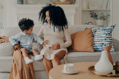 little-boy-touching-belly-of-his-pregnant-mom