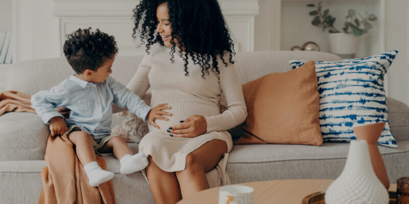 little-boy-touching-belly-of-his-pregnant-mom
